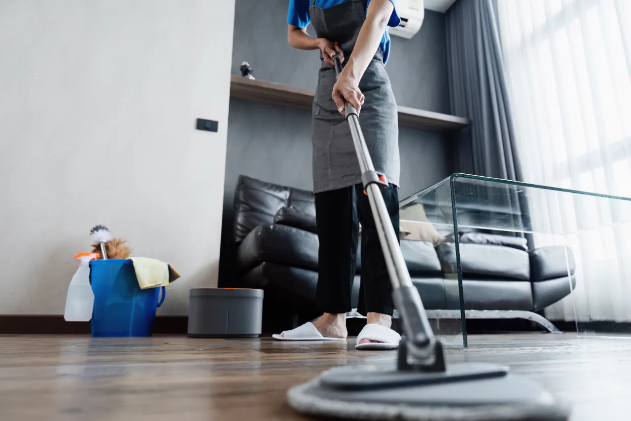 Wood floor mopping during apartment cleaning in New York