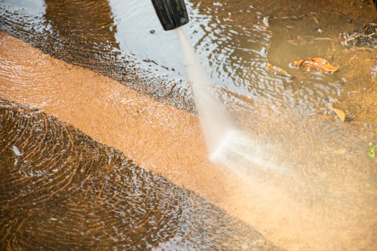 Pressure washing concrete surface in New York