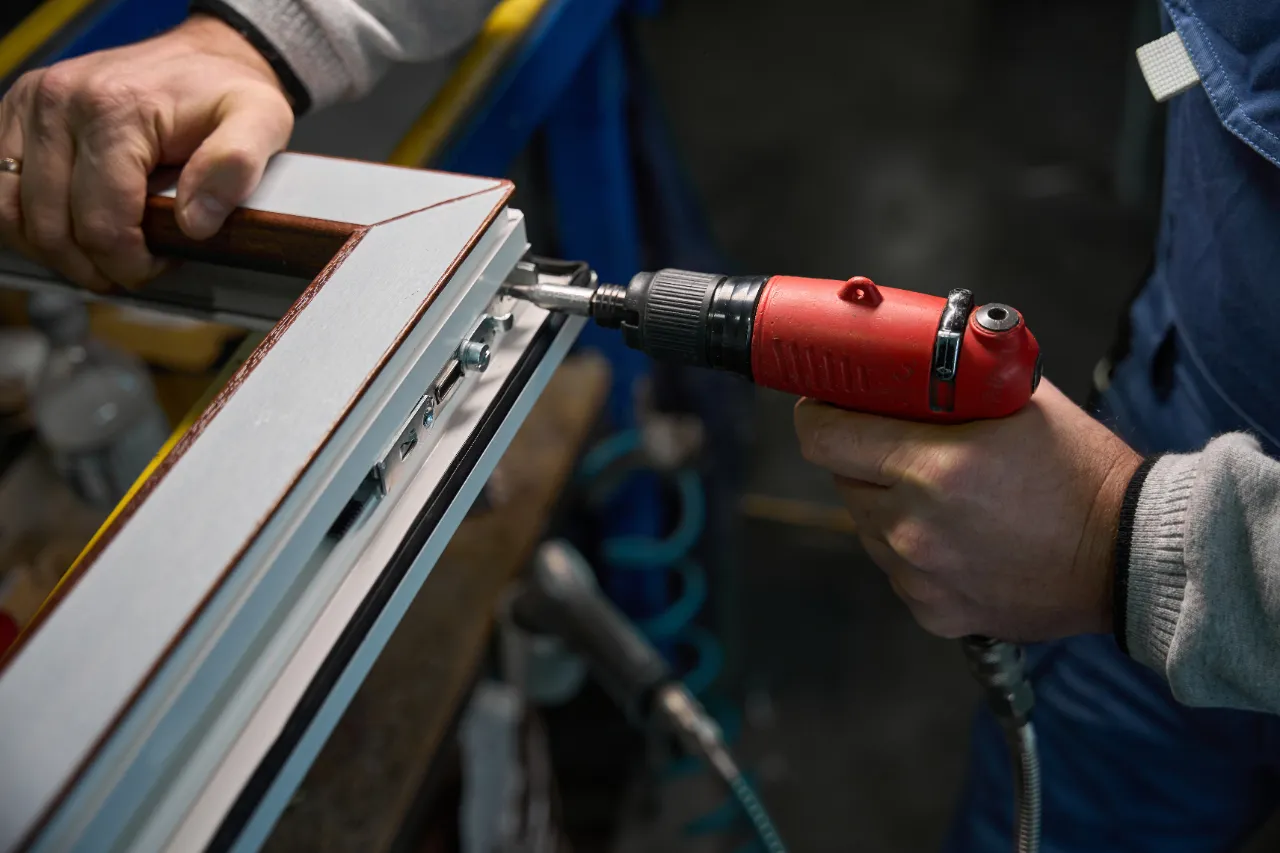Window hardware repair with power drill in New York