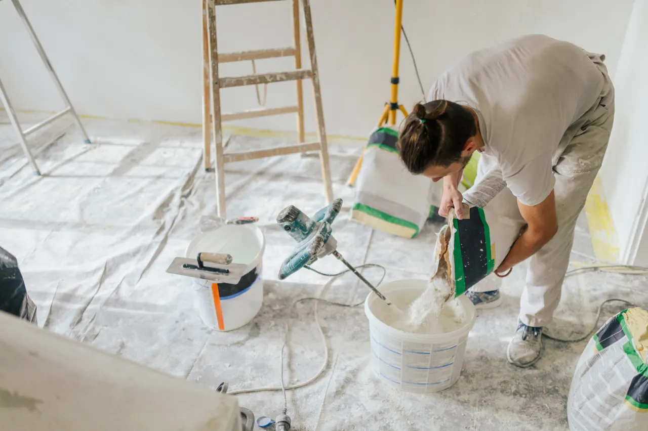 Mixing wall plaster for drywall repair in New York