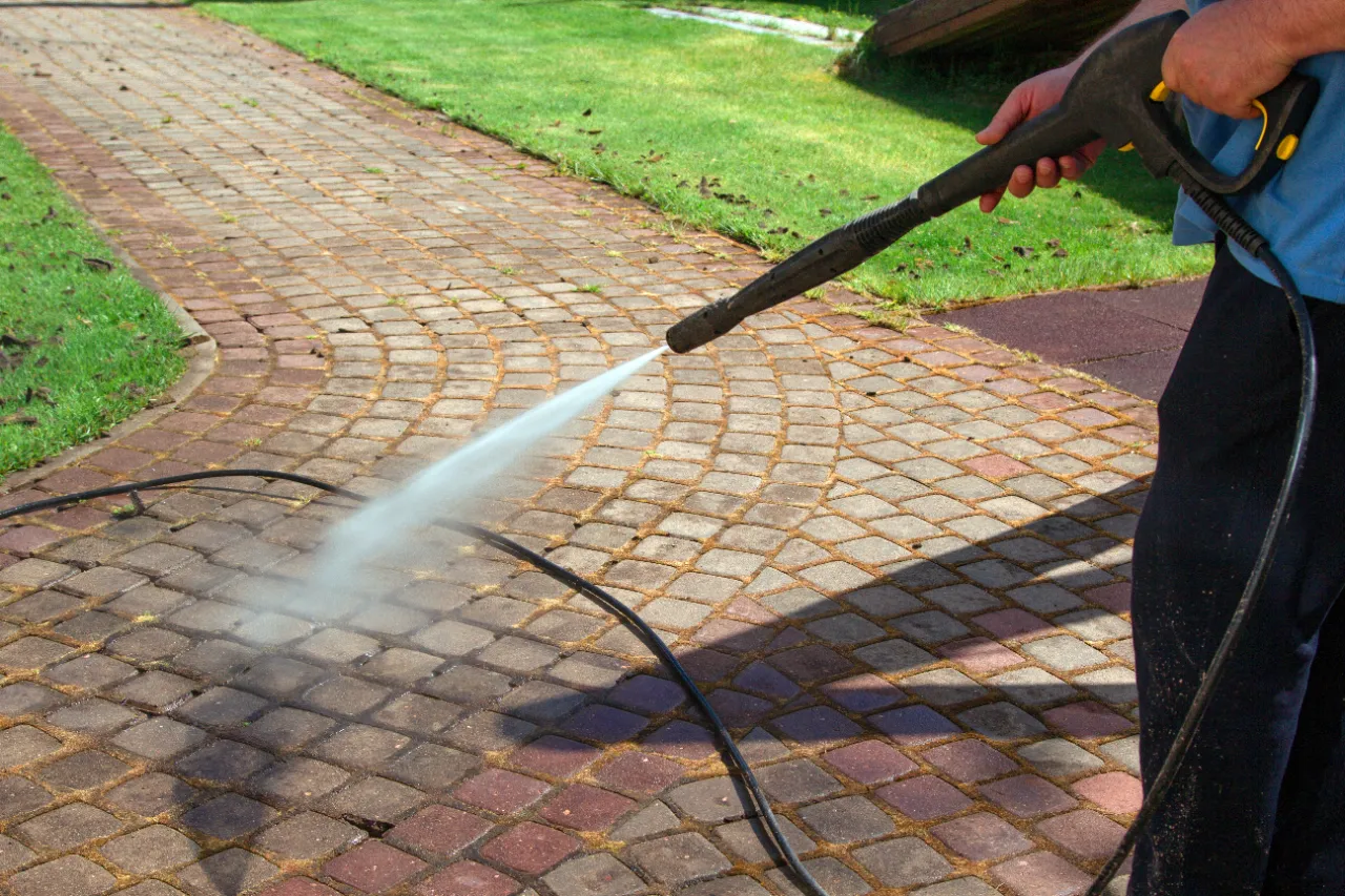 Power washing a brick path in New York