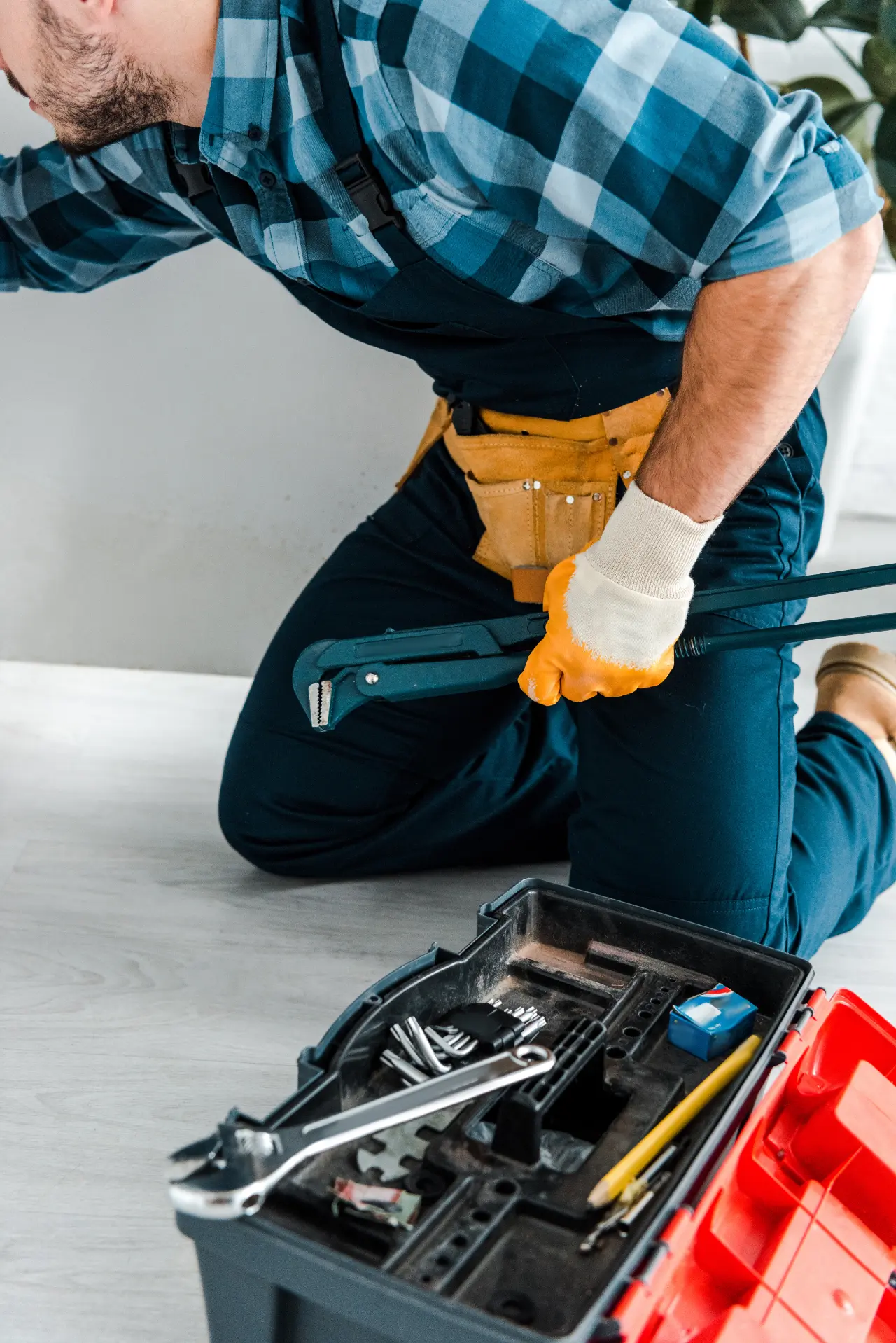 Plumber fixing a small leak in a NYC apartment