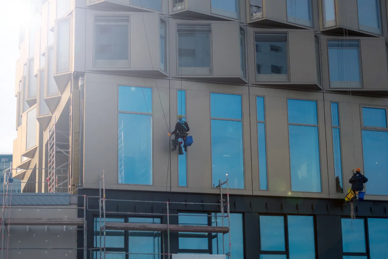 Window cleaners working on a building facade in New York